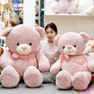 Gấu Bông Teddy Hồng Lông Xoắn Ngực Tim Đeo Nơ